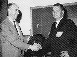 R.L. Swiggett (left) receiving a plaque from W.J. McGinley in recognition of Swiggett's leadership and distinguished service as IPC President in 1961 and 1962.