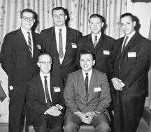 First members of the Standards Coordinating Committee. Seated: Bob Matzinger, Martin-Marietta; Gene Szukalski, RCA. Standing: Lynn Gunsaulus, Photocircuits; Hugh Medford, Westinghouse Electric; Stark Roberts, IBM; and Dean Stephenson, Amphenol.