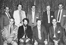 The experts who served on the historic first "measles" committee. Seated: Frank Papiano, RCA; Dick Castonguay, Mica; Ed Cuneo, Cinch-Graphik; and Chairman Jim Swiggett, Photocircuits. Standing: Arny Andrade, Sandia; George Knox, Uniglass; George Smith, NSA; Charles Moser, Bureau of Engraving; and Dick Sarazin, Norplex.