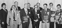 Receiving the IPC President's Award: (five in front) Jim Hardman, AMP; Fred Disque, Alpha Metals; John Reust, Beech Aircraft; Foster Gray, Texas Instruments; and Pete Gilmore, Hamilton Standard; (in back) Jim DiNitto, Raytheon; Jack Kerr, USN Electronics; Robert Moore, Sperry; Paul Gould, GTE Sylvania; and Tom Brown, FabriTek. Click the picture for a larger image.