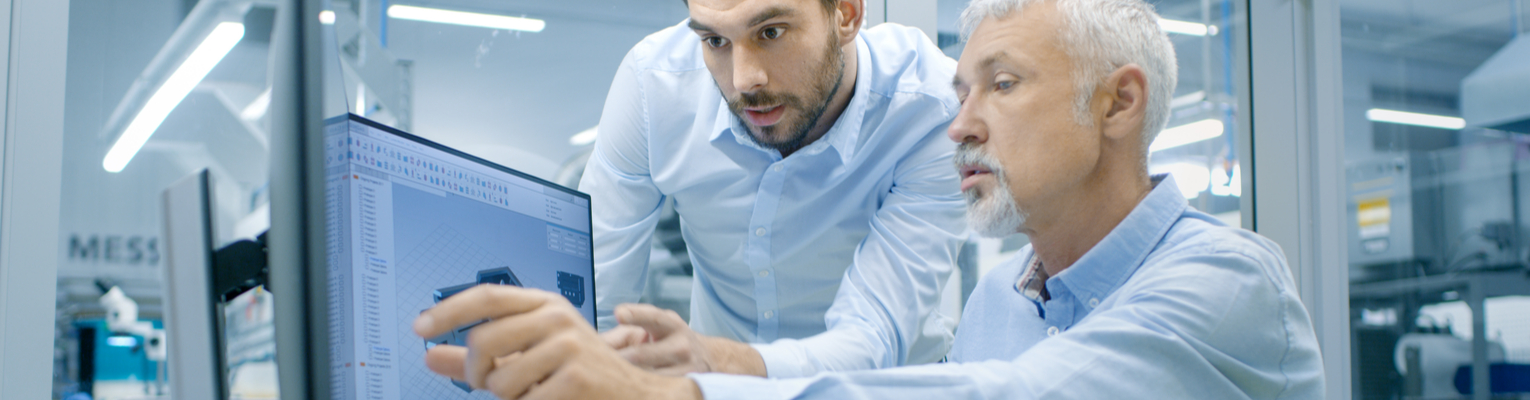 Two engineers discussing Design for Manufacturability